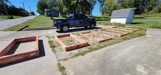 Cedarwood Raised Beds being installed on site lining a Driveway